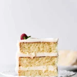 Delicious homemade vanilla cake with creamy frosting and fresh berries