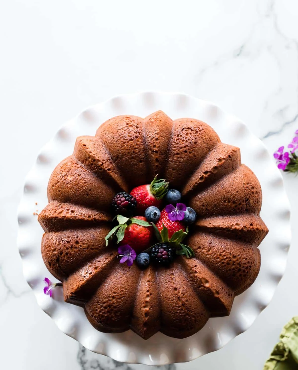 Delicious cream cheese pound cake on a white plate.