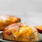 Freshly baked peach cake with slices of ripe peaches on top