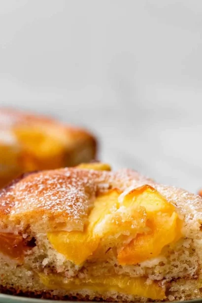 Freshly baked peach cake with slices of ripe peaches on top