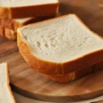 Homemade gluten-free sandwich bread recipe showcasing a fluffy loaf sliced for sandwiches.