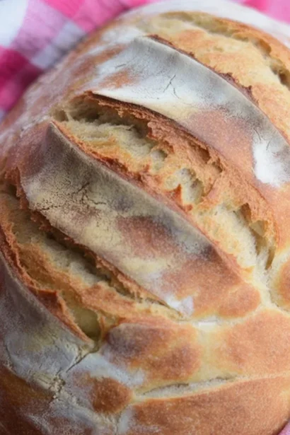 Freshly baked no-knead artisan bread with a crusty exterior and soft interior.