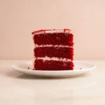 Delicious slice of BEST Red Velvet Cake topped with cream cheese frosting.