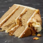Delicious Biscoff Cake topped with cookie crumbs and caramel drizzle