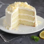 Delicious slice of Italian Lemon Cream Cake with lemon zest and cream topping