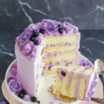 Delicious Lavender Cake with floral decoration and slice on a plate