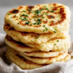 Freshly baked fluffy Turkish milk bread loaf on a wooden cutting board.